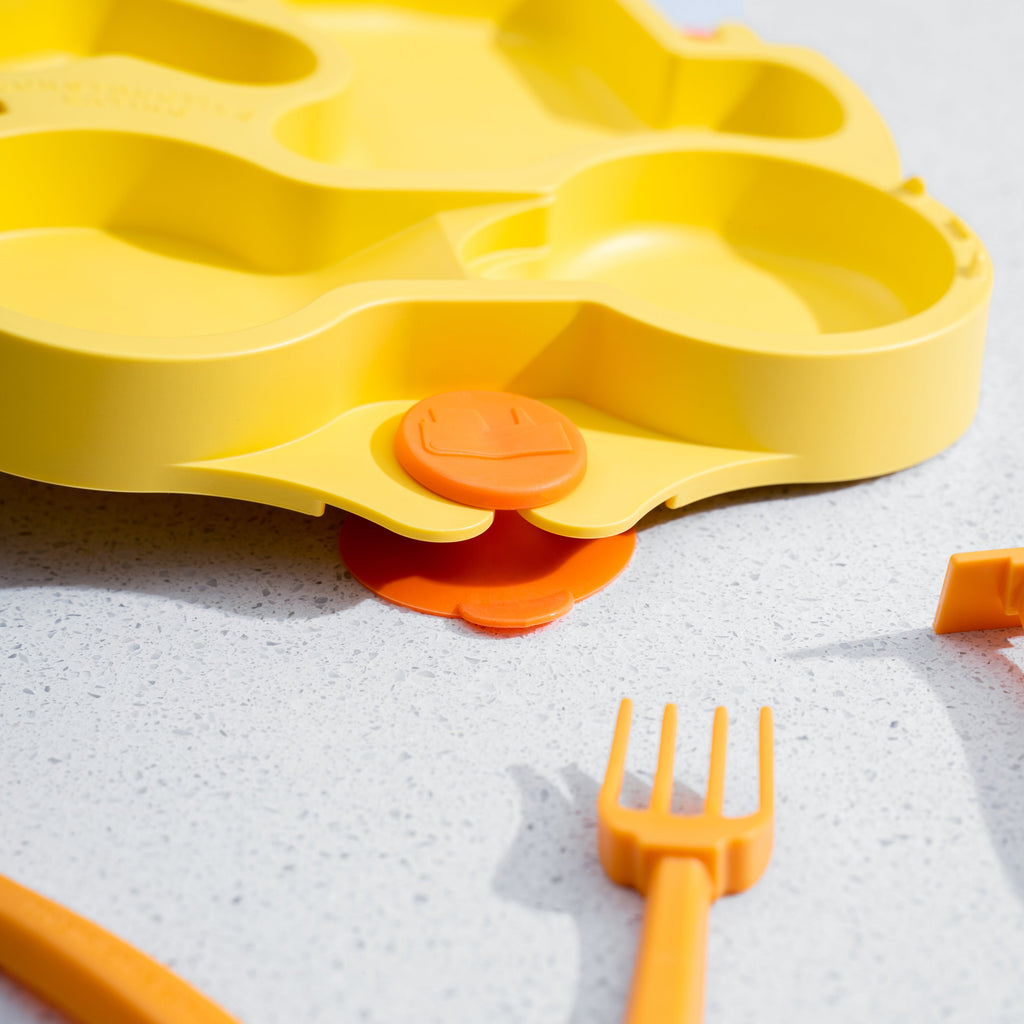 Image showing the suction strength of the training plates. One side of the plate is being lifted while the suction cups keep the other side of the plate stuck to the table.